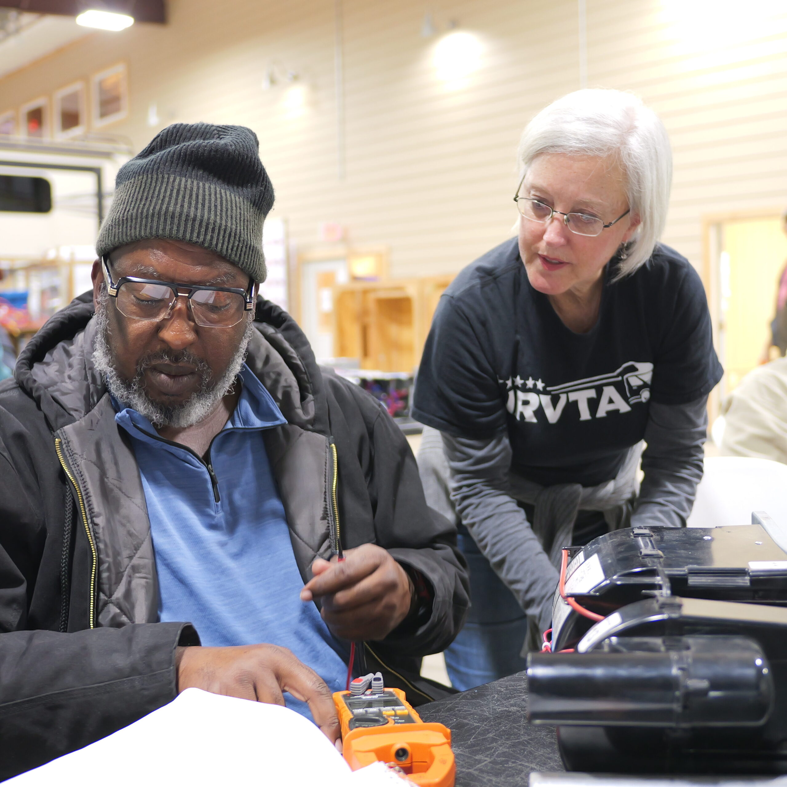 Susan Rasmussen teaching an NRVTA student hands on water heater troubleshooting
