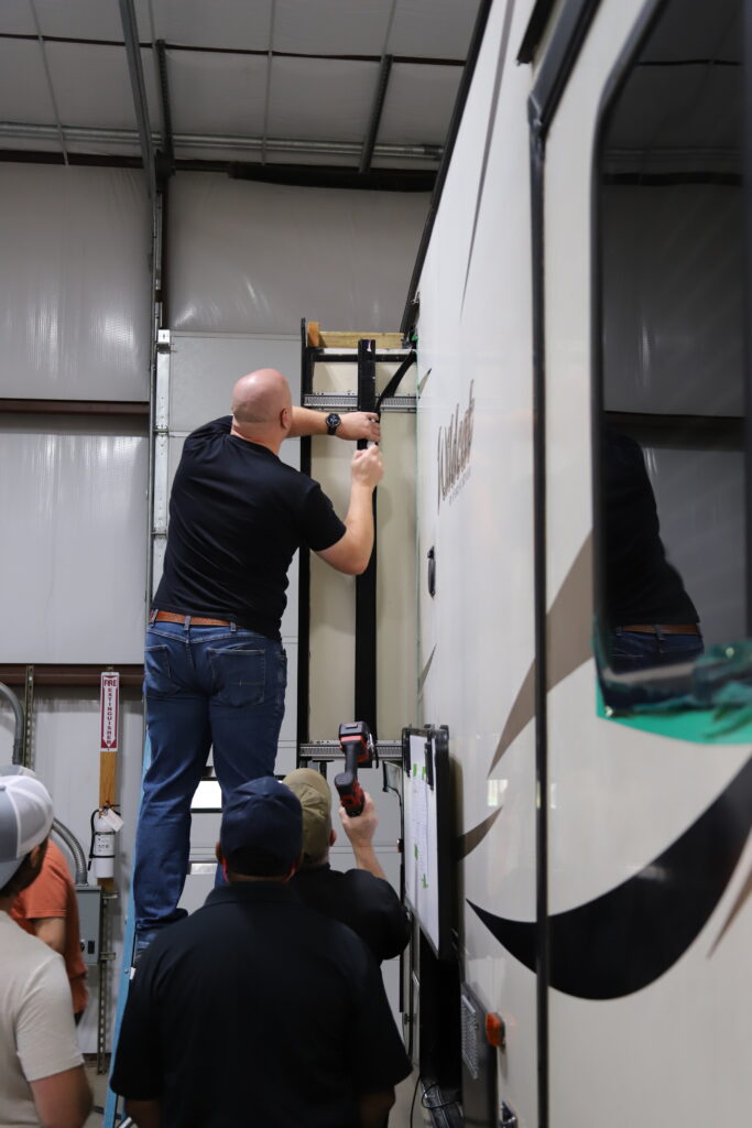 Student learning hands-on RV technician training at the National RV Training Academy.