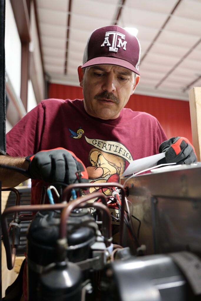 Student learning hands-on RV technician training at the National RV Training Academy.
