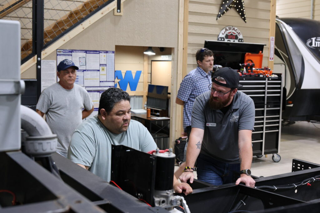 Student learning hands-on RV technician training at the National RV Training Academy.
