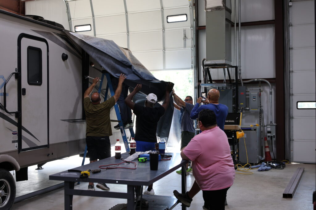 Student learning hands-on RV technician training at the National RV Training Academy.