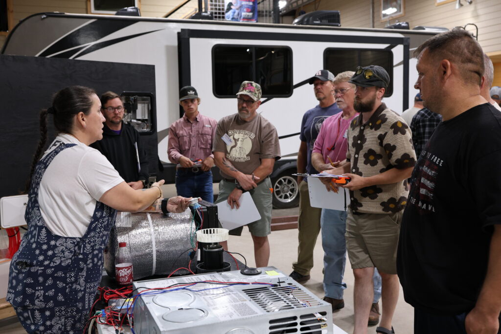Student learning hands-on RV technician training at the National RV Training Academy.